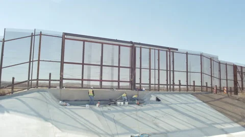 Wide Shot of Construction Workers Near Border Fence Stock Footage 60386577