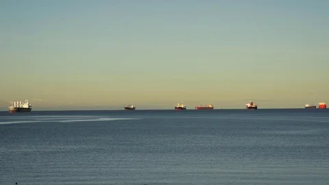 Wide shot of container ships anchored in English Bay at dawn Stock Footage 69724763