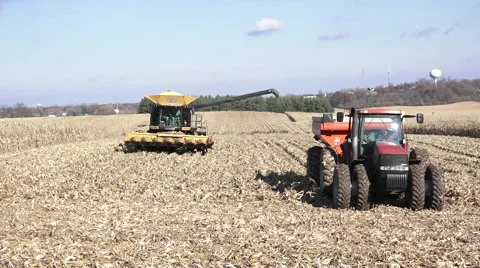Wide shot corn combine and wagon Stock Footage 56867385