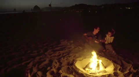 Wide shot of couple by fire Stock Footage 54055199