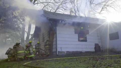 Wide shot of crouching firemen Stock Footage 60737127