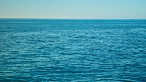 Wide shot of deep blue ocean with distant snow-covered mountains, in Iceland. Stock Footage 293634878