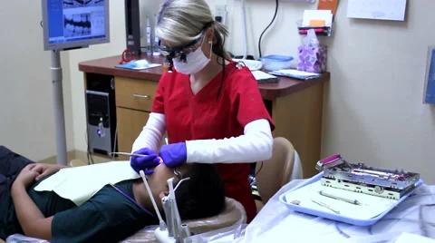 Wide shot of dentist cleaning teeth Stock Footage 50809538