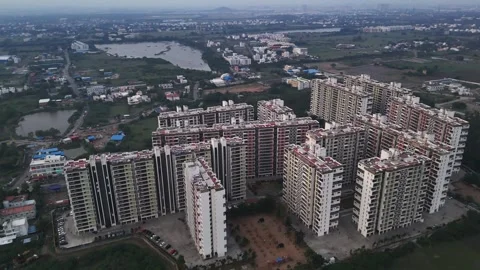 A wide shot of a developing cityscape. The footage features a large complex of 스톡 동영상 317692635