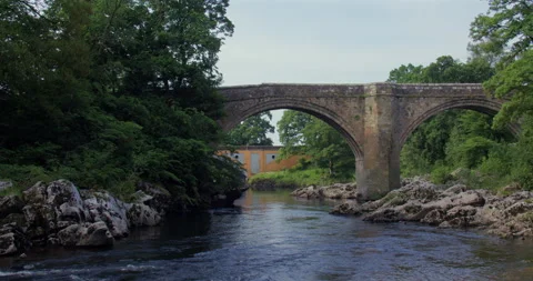 Wide Shot of the Devils bridge from the river Lune with Stanley bridge in Stock Footage 328891795