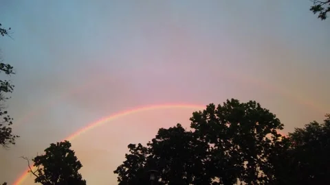 Wide Shot of Double Rainbow behind Silhouette of Street Lamp Post in Park at Stock-Footage 336954812