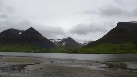 Wide Shot of Dramatic Icelandic Mountain Landscape with Fjord and Overcast Sky Stock Footage 339763923