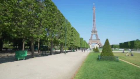 Wide shot of the Eiffel Tower in front of the Champs de Mars park in Paris Stock Footage 90026780