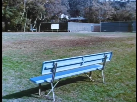 Wide shot of empty bench on baseball field Vídeos de archivo 260254514