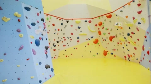 Wide shot of empty boulder climbing indoor gym with various types of walls Stock Footage 221249028