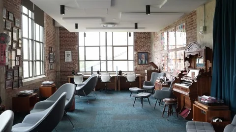 Wide shot of empty industrial office with brick walls and vintage furniture Stock Footage 336350759