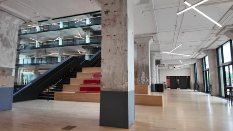Wide shot of empty modern industrial office with concrete pillars and stairs. Stock Footage 336352031
