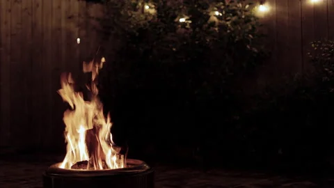 Wide shot of a fire in a backyard firepit Stock Footage 221873325