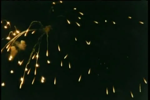 Wide shot fireworks exploding in night sky Stock Footage 11346892