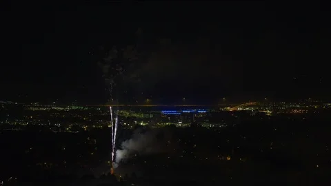 Wide shot of fireworks exploding in sky over cityscape at night / Pleasant 库存影片 96659388