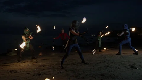 Wide shot of five talented fire artists of mixed-gender performing together. Stock Footage 144747722