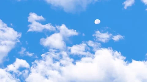 Wide-shot full moon setting, blue sky white clouds Stock Footage 291461866