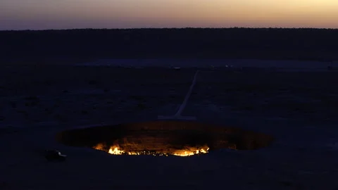 Wide shot of the Gate of Hell / Darwaza crater at blue hour, 4K, DNxHR Stock Footage 150430801