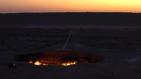 Wide shot of the Gate of Hell / Darwaza crater at dusk, 4K, DNxHR Stock Footage 150443616