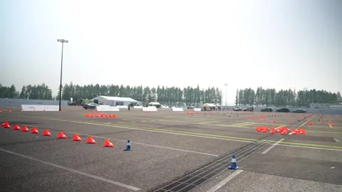 WIde shot of Geely driving course with traffic cones at the automotive test Stock Footage 335995854