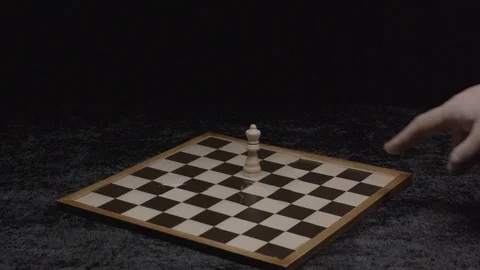 Wide shot on a hand taking down the queen on a chessboard Slow motion at 200Fps 스톡 동영상 103545497