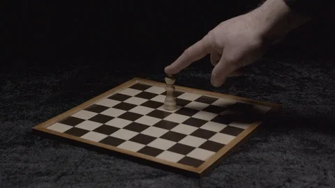 Wide shot on a hand taking down the queen on a chessboard Slow motion at 200Fps Stock Footage 103548167