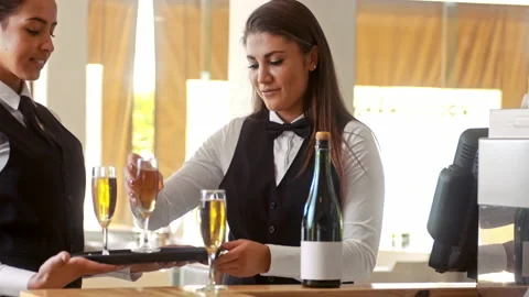 Wide shot of happy manager calling waiter to deliver full champagne glasses to c Stock Footage 199633717