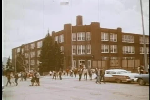 Wide shot of high school students leaving school Stock Footage 11357193