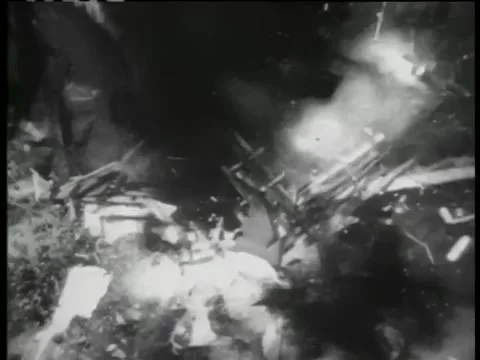 Wide shot of hut exploding after bombing 库存影片 260254034