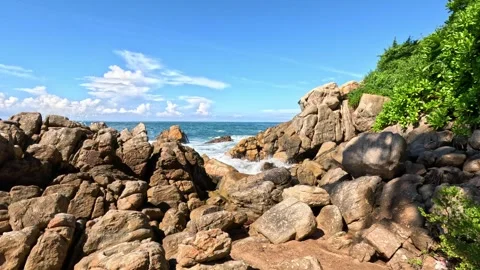 Wide shot of Indian Ocean waves crashing on breakwaters with large rocks Stock Footage 339899214