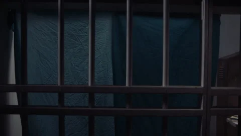 Wide shot of inmate hanging up sheet for privacy, 2000s, USA - Reenactment 스톡 동영상 243735680