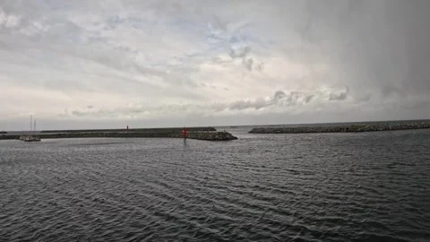 Wide shot inside Andenes harbor facing breakwater exit with red buoys in Norway Vidéo 342755872