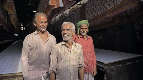 Wide shot of Laborers working in the textile printing industry smiling. Stock Footage 96187582