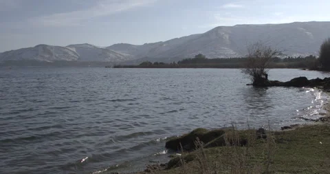 Wide Shot of Lake Sevan Shoreline with Mountains, Armenia Stock Footage 326632424