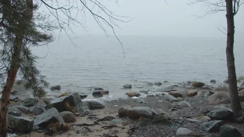 Wide shot looking out over misty lake in National Park in Finland Stock Footage 146270219