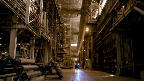 Wide Shot Low Angles of Forklift in Modern Factory - Flag in Foreground Stock Footage 89944500