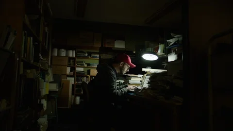 Wide shot of a man looking through architectural blueprints Vídeos de archivo 124978898