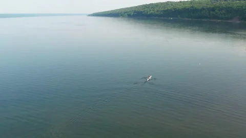 Wide shot man rowing on lake Stock Footage
