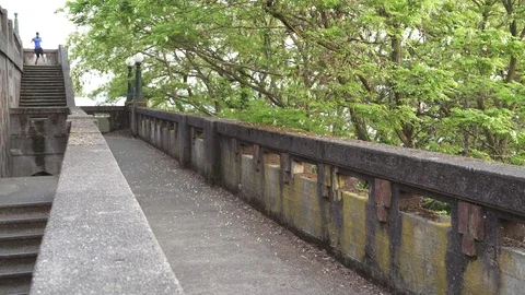 Wide shot of man running down on stairs 스톡 동영상 76236644