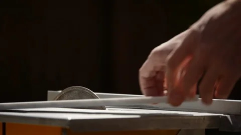 Wide shot of a man's hands cutting subway marble stone on a wet saw. Stock Footage 129102237