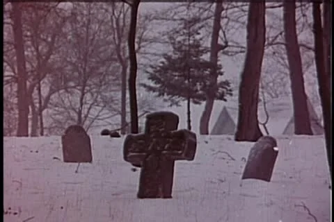 Wide shot of men carrying coffin through cemetery in winter Stock Footage