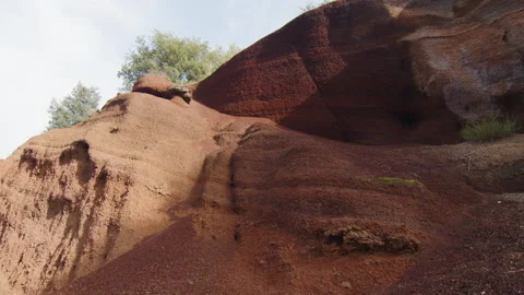 Wide shot of a mound of red ochre earth in the middle of nature, in Spain Stock Footage 223914571