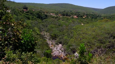 Wide shot of the mountains in the Vale do Capao and a brown stream, Brazil Stock Footage 237477645