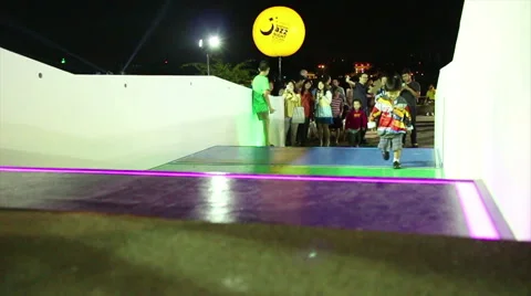 Wide shot multiple people run up and down illuminated glowing stairs in slo-mo Video stock 62656032