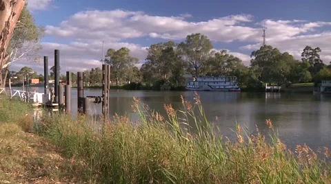 Wide shot of the Murray River with paddle steamer on opposite bank Stock Footage 65365250