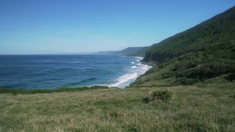 Wide shot ocean wave hit rock at coast Stock Footage 86886599
