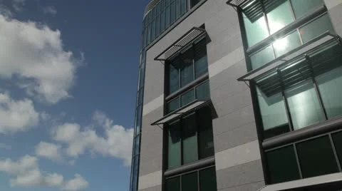 Wide shot of office block with clouds passing Stock Footage 12193304
