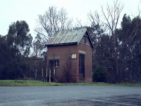 Wide shot of an old abandoned building. Camera pans across to reveal scenery. Stock Footage 79904967
