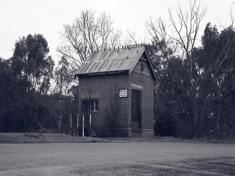 Wide shot of an old abandoned building. Camera pans across to reveal scenery. Stock Footage 79904968