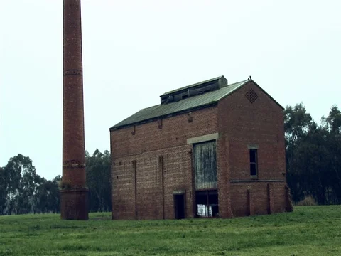 Wide shot of an old abandoned building. Camera tilts to the sky. Stock Footage 79905373